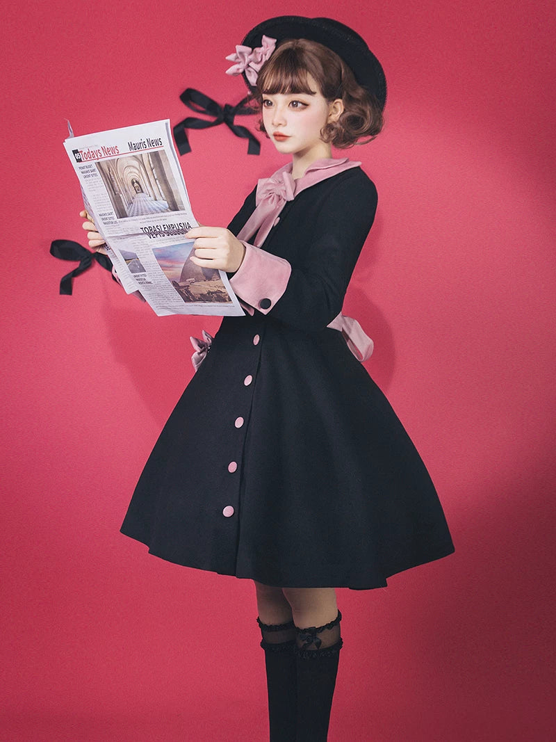 Baozi Pig black-and-pink OP dress with a sailor collar and back bow against a pink studio backdrop.