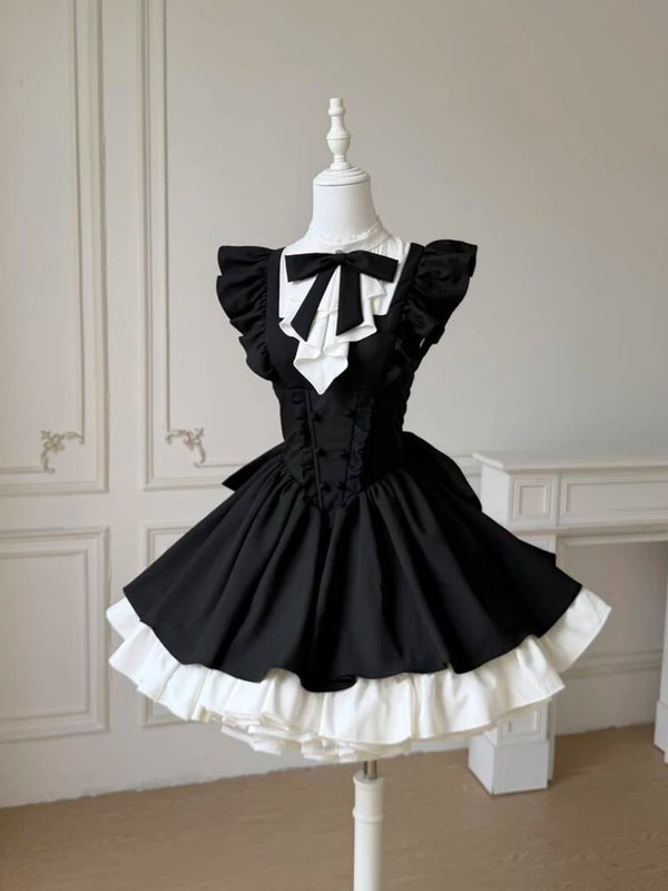 Black Lolita one-piece dress with ruffled flutter sleeves, large structured back bow, and contrasting white yoke panel, displayed on a mannequin