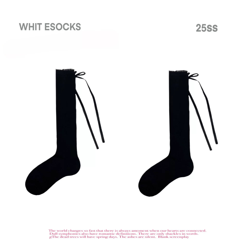 Black and white patterned openwork socks styled with metallic shoes.