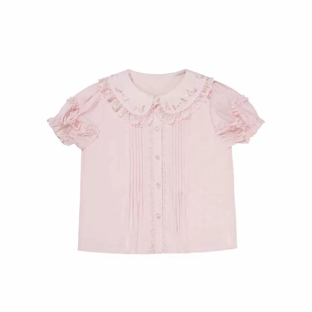 Soft pink short-sleeve blouse with an embroidered Peter Pan collar, lace trim and front pleats.