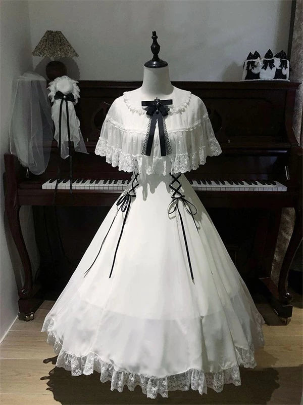 White Lolita dress displayed on a mannequin, with a lace-trimmed overlay, black chest bow, side ribbon lacing, and full skirt.