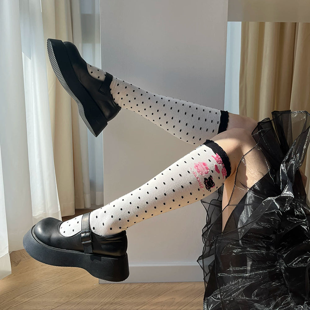 roji roji dotted mid-calf socks with graphic accents styled with black shoes.