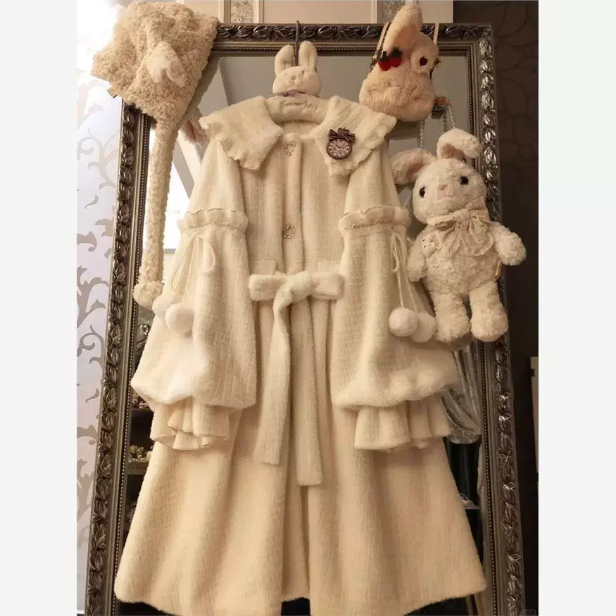 Winter Sunlight fleece-lined coat with rounded collar, front bow, and pom-pom pocket ties