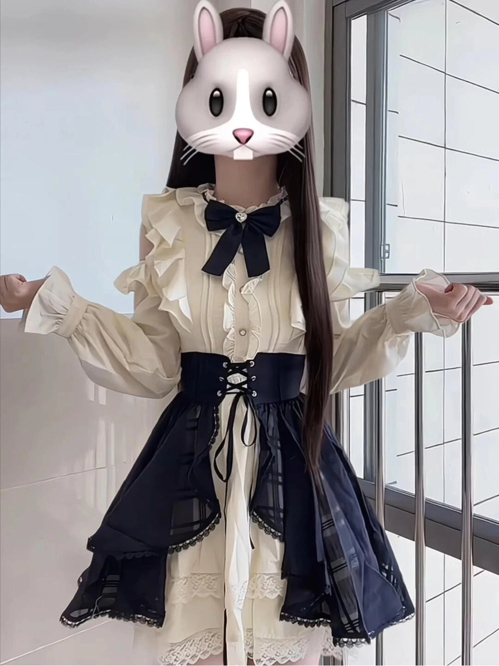 Cream-and-black layered dress set with ruffled sleeves and a lace-up waist.