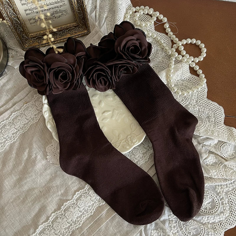 White and grey layered legwear with lace stockings, a leg ring and pearl-like chains.