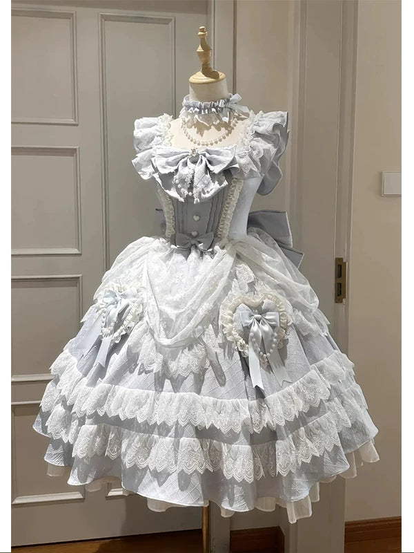 Creamy blue and white Lolita dress with tiered lace and a large back bow on a mannequin