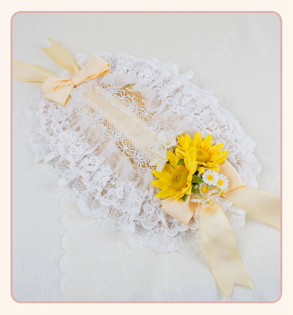 Lace flat straw hat with a large yellow bow and floral embellishment.