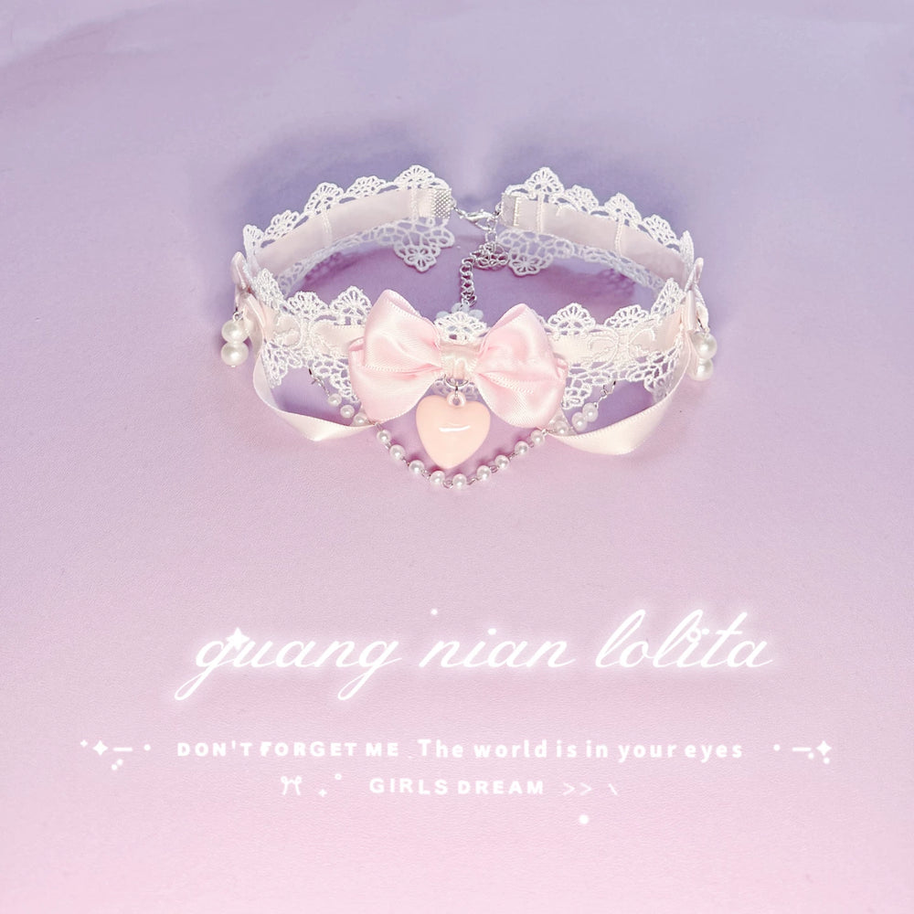 White lace choker necklace with a pink bow, pearl details, and a heart pendant on a lavender background