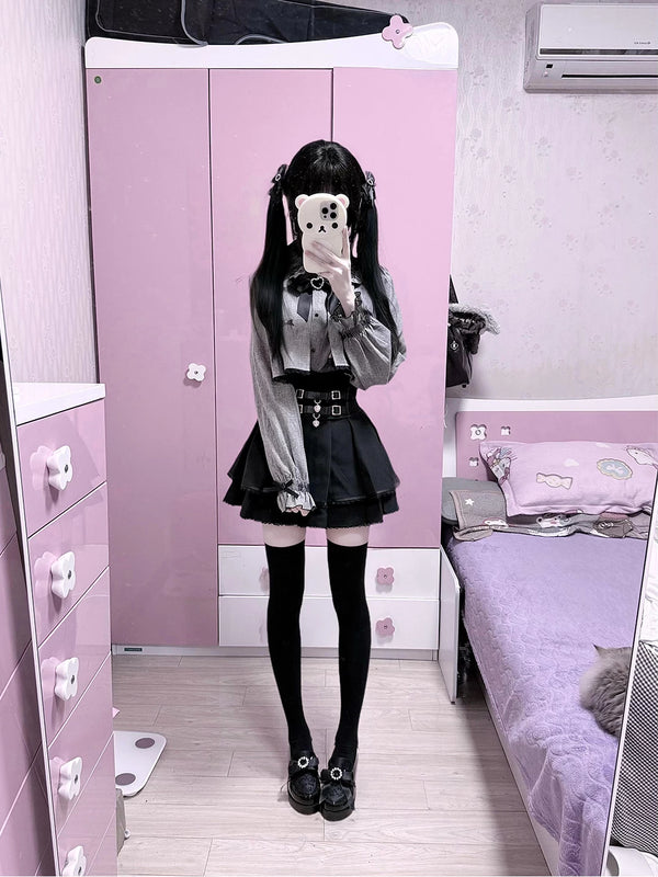 Grey cape-style top and black high-waisted skirt set in mirror photos