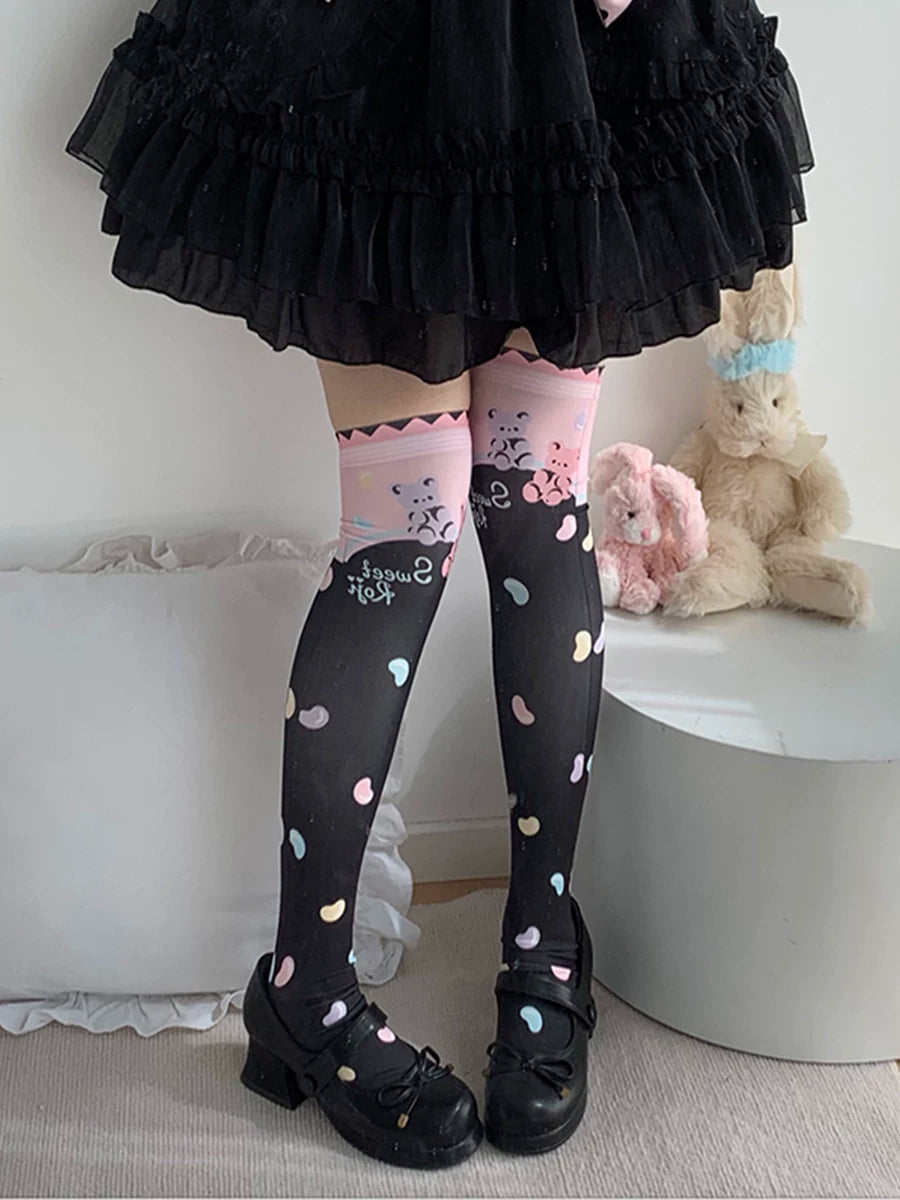 Black and white over-the-knee socks with pastel candy motifs