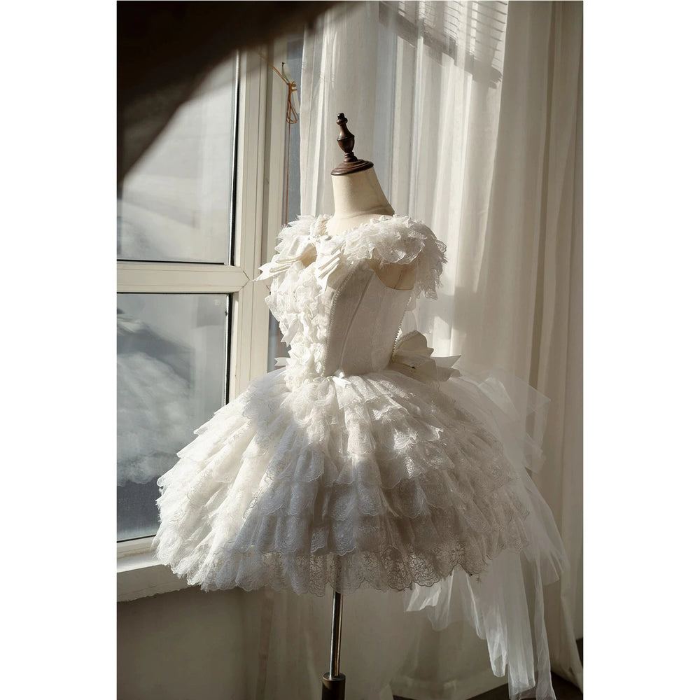 Creamy white lace JSK dress with layered skirt, train and shawl details displayed on a dress form.