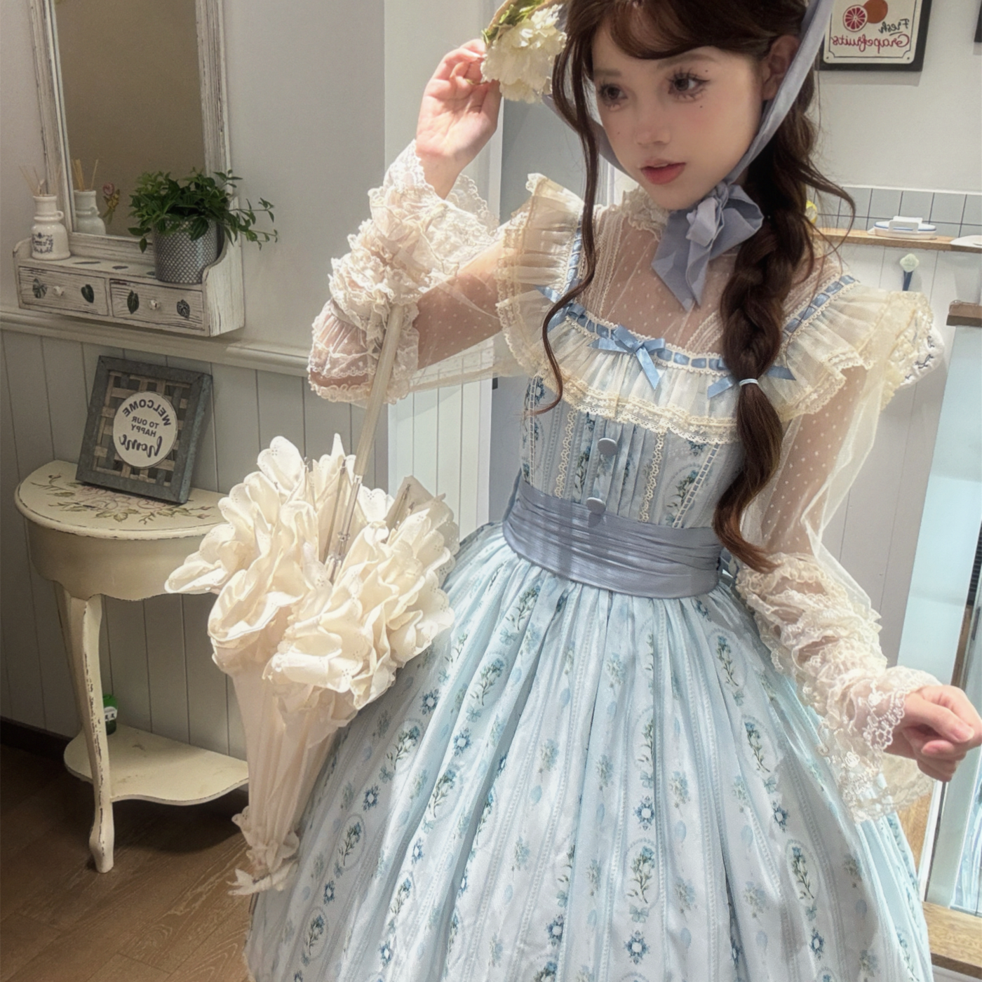 Pumpkin Planet light blue floral-print JSK shown on a model with a waist sash