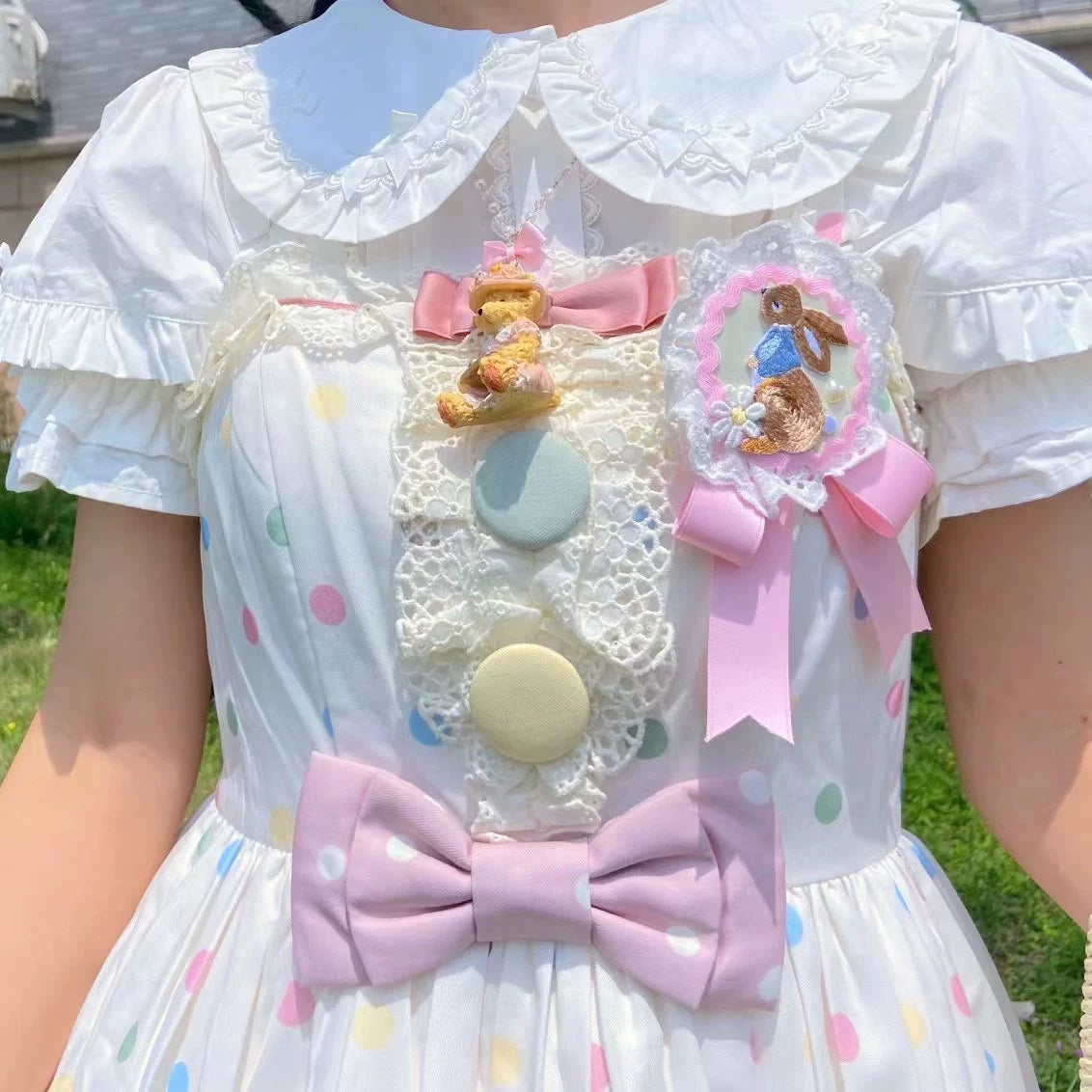 Bear doll beaded necklaces with animal and bear pendants, beaded chains, and pastel bows arranged on pink doilies.