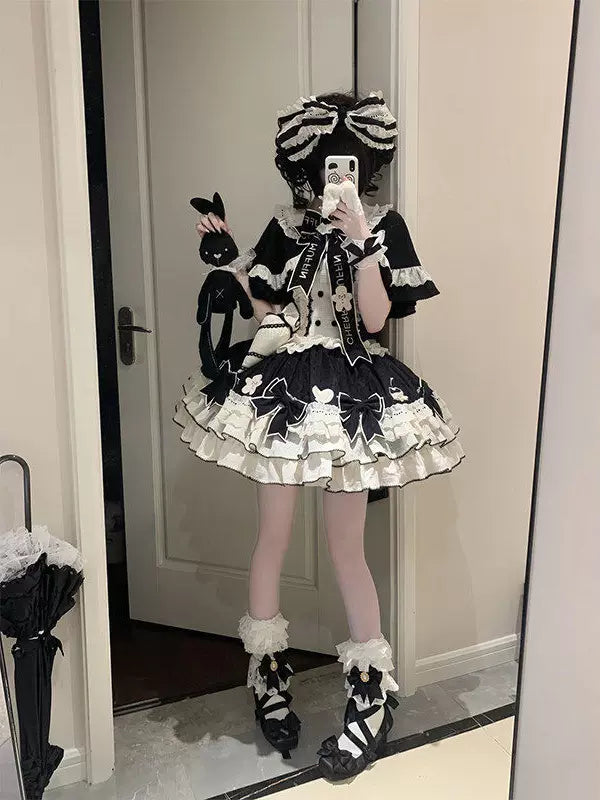 Black-and-white JSK dress coordinate with a cape, train, sleeves and oversized bows.