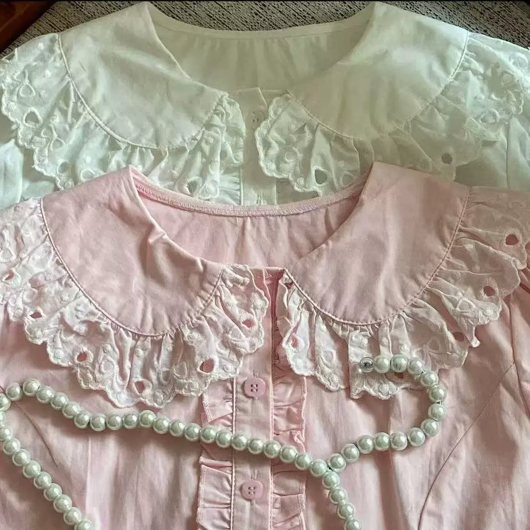 White and pink short-sleeved blouses with rounded collars and eyelet lace.