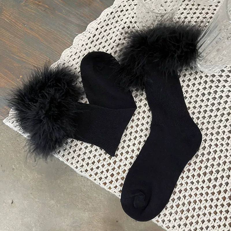 Purple ribbed mid-calf socks with plush pom-pom heel trim