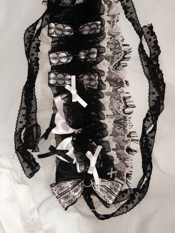 Heavily embellished black, pink and white lace hairband with layered bows and cross accents.