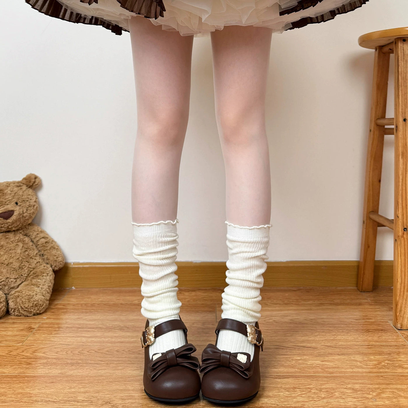 Off-white slouchy mid-calf socks with a ruched shaft and scalloped top edge.