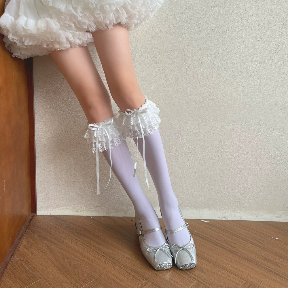 White mid-calf Sweet Lolita sock with lace trim and bow accent