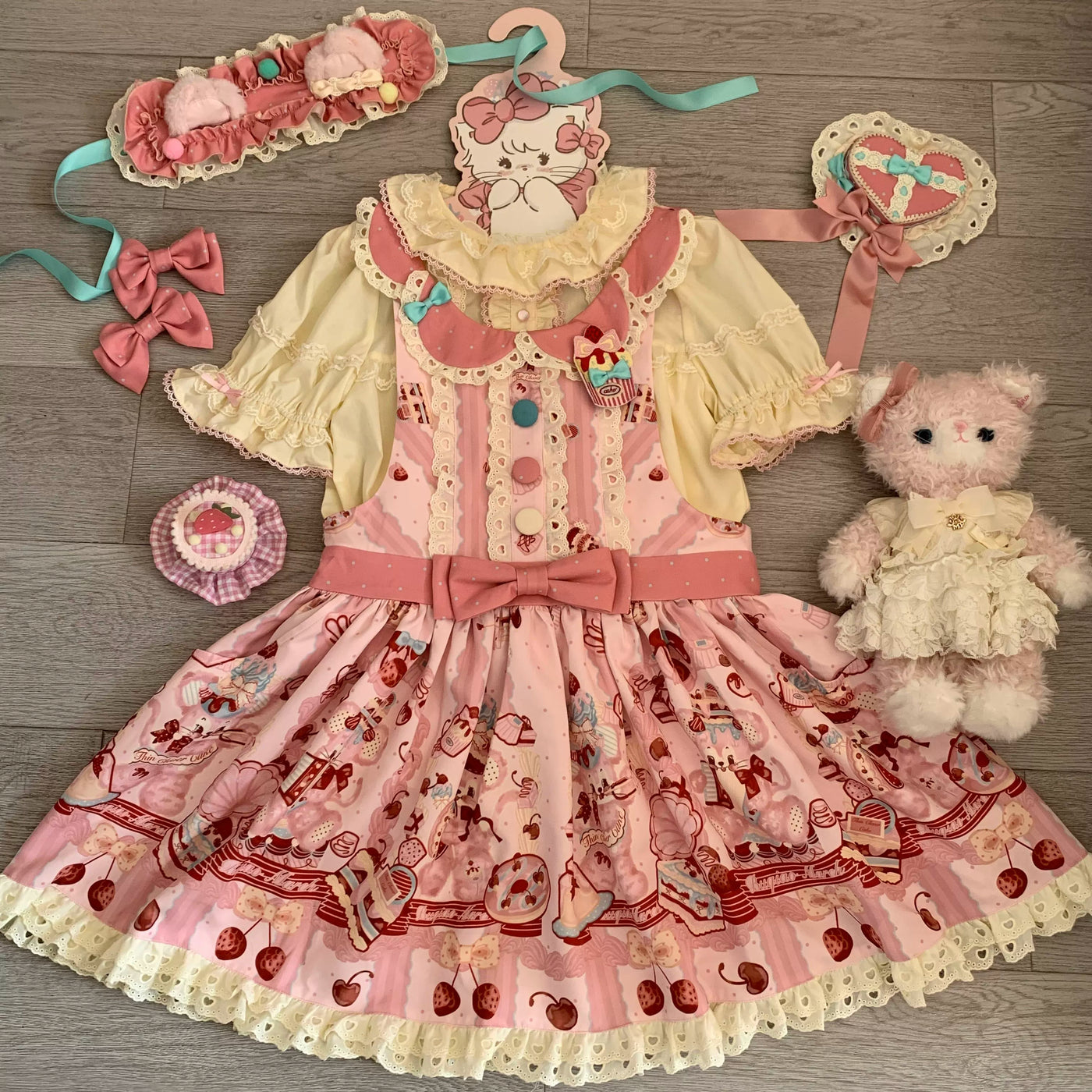 Pink printed JSK with cherry and dessert motifs arranged with bows and coordinate accessories.