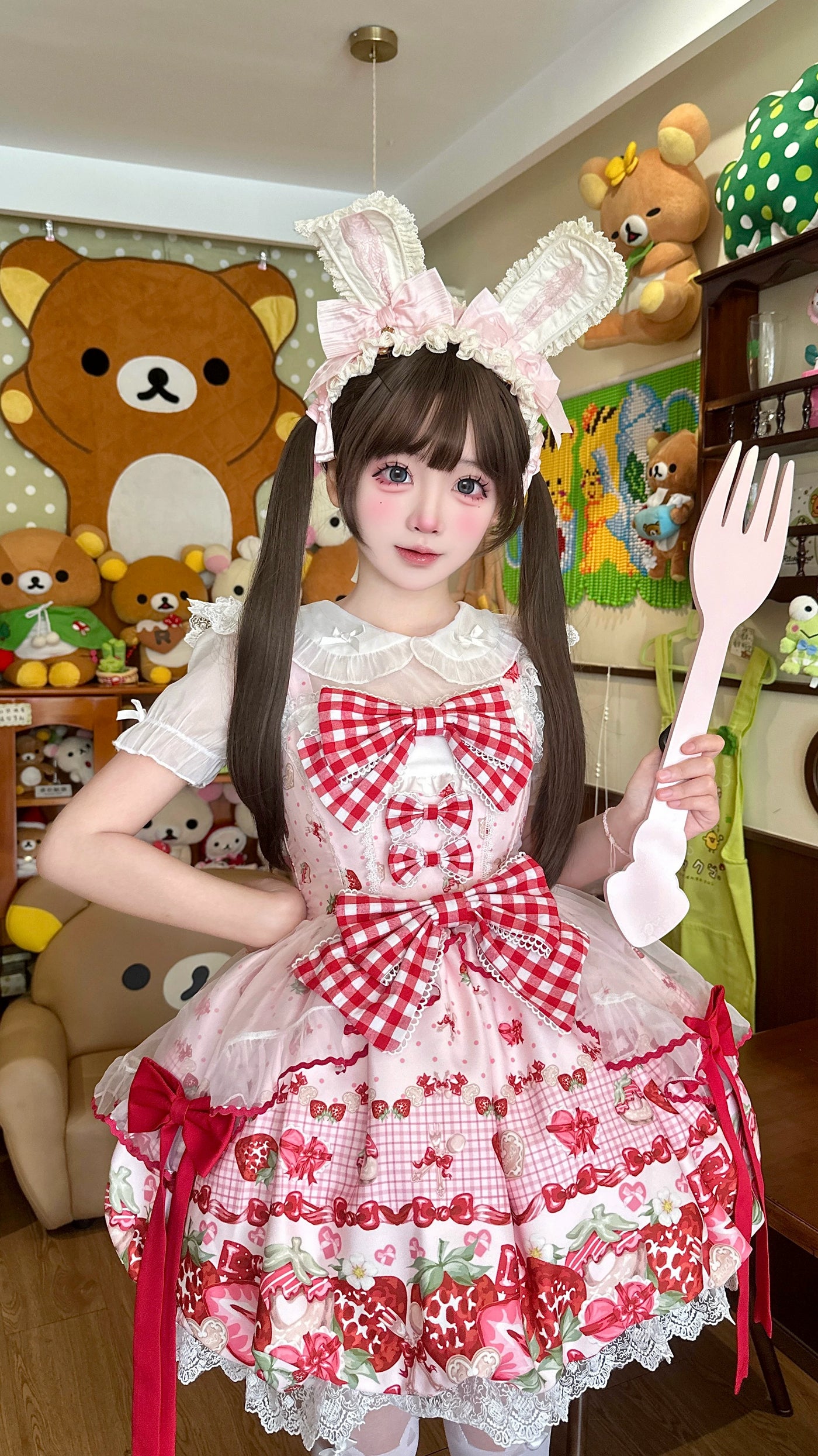 Close-up of the JSK's strawberry print, gingham bow and lace trim details