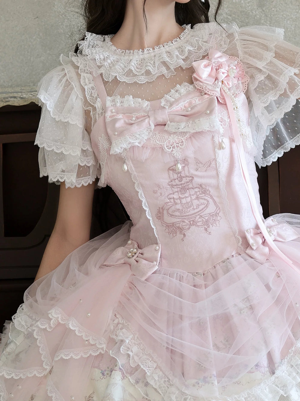 White lace-collar short-sleeve Lolita inner top layered beneath a pink dress.