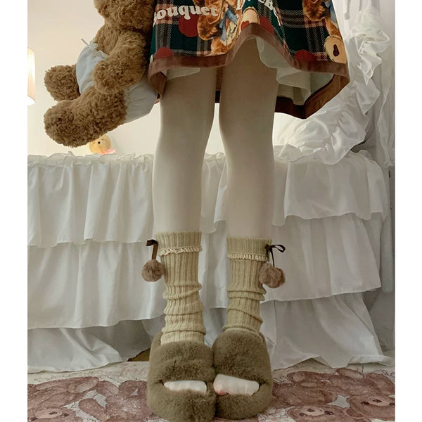 Coffee-color knit leg warmers with ribbon ties and pom-poms