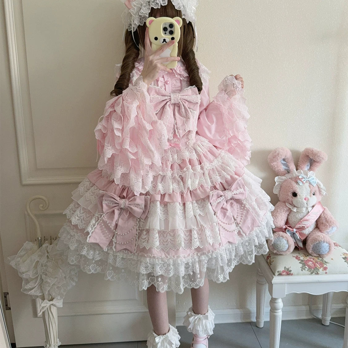 Lady Han Cross Heart Knot Sweet JSK Dress by Lolita Fetch featuring a charming pink dress with cross-heart knot details and bow accents.