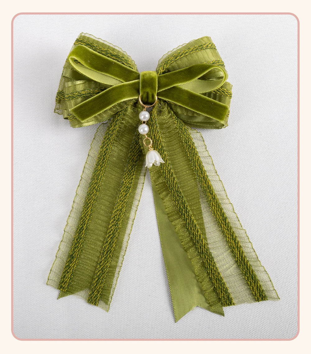Stardust Rose green-and-white lace headwear with floral ribbons