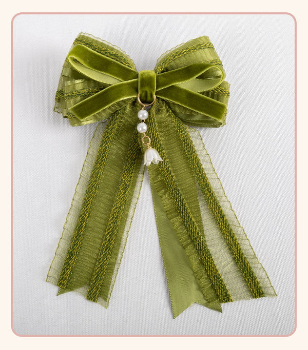 Stardust Rose green-and-white lace headwear with floral ribbons