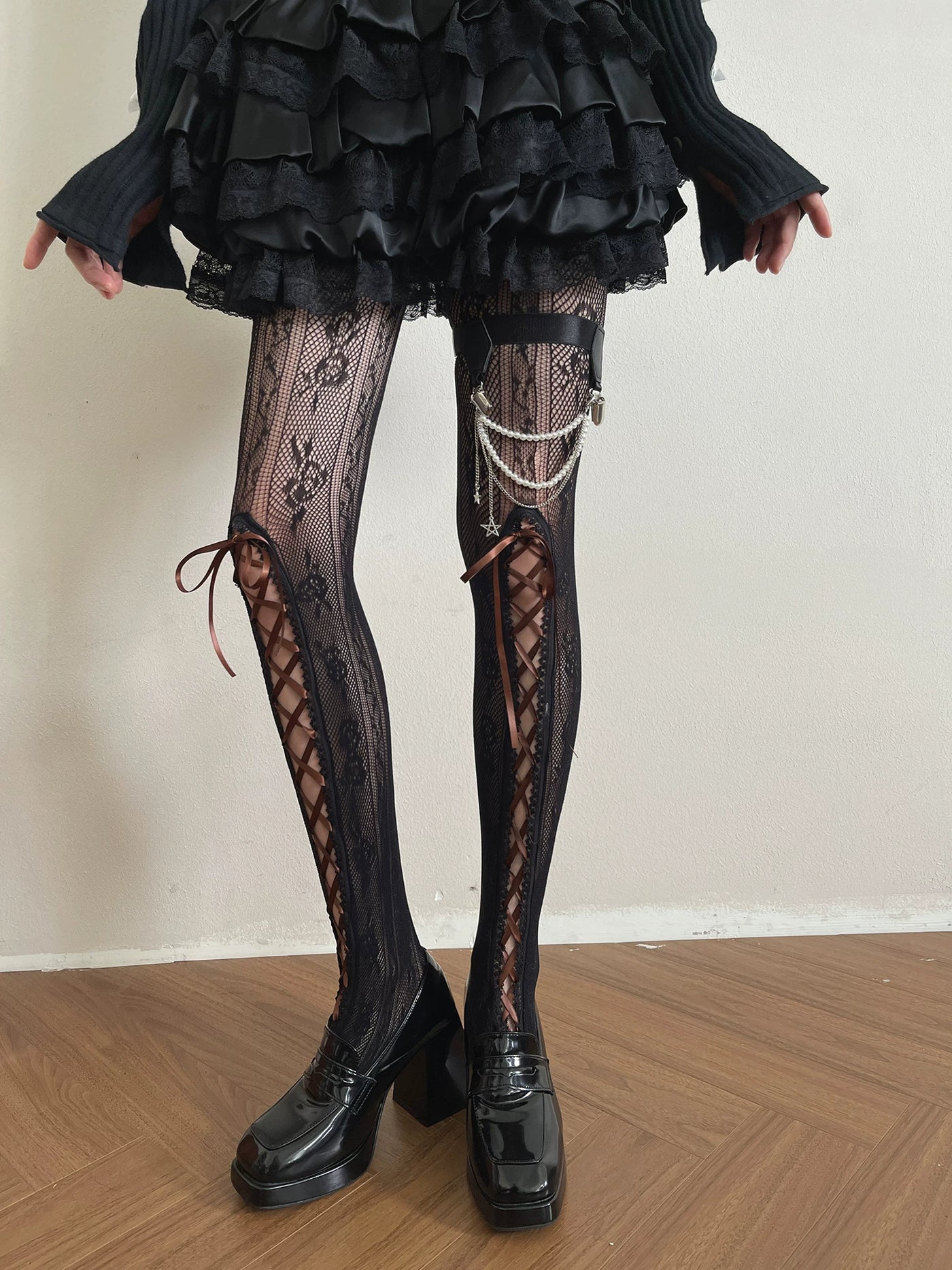 Black floral lace tights with long side lacing shown on a model.