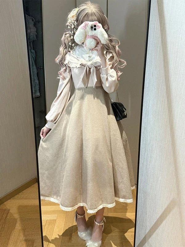 Cream-toned Lolita dress with a large bow and full A-line skirt shown in a mirror.