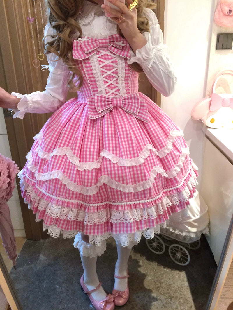Full view of the sweet lolita JSK paired with a white blouse, knee-high socks, and pink Mary Jane shoes