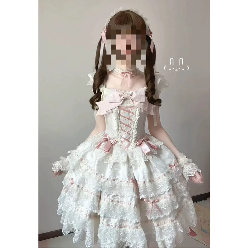 Creamy apricot JSK dress set with layered lace tiers, pink bows and a train.