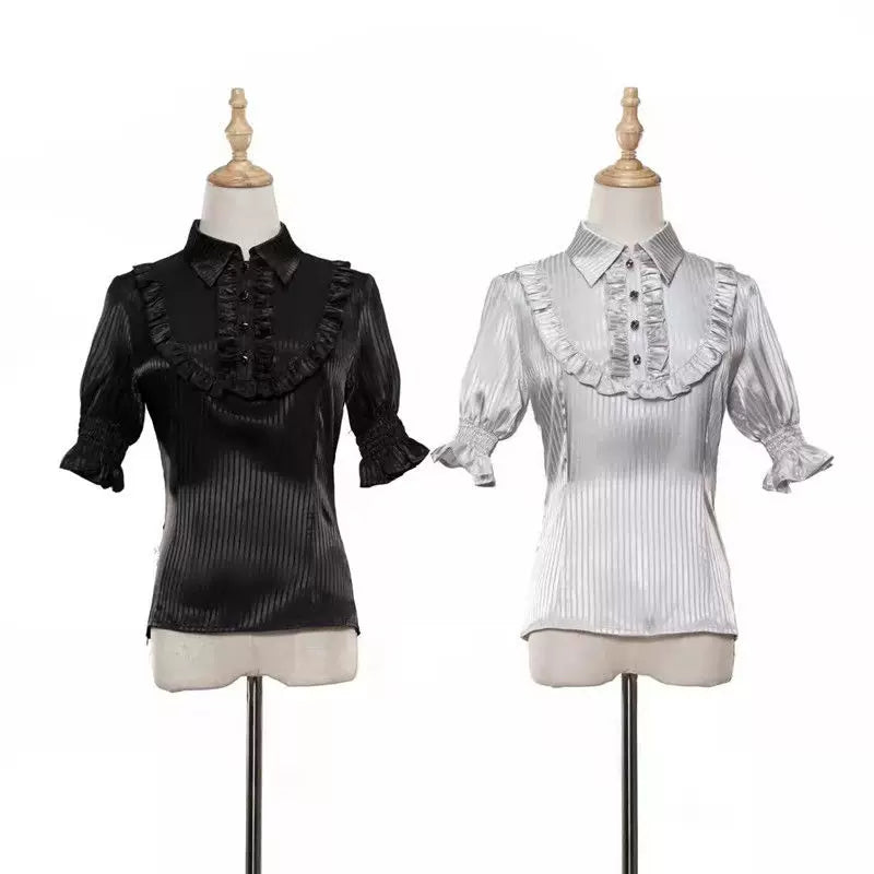 Black and grey short-sleeved striped shirts with pointed collars on dress forms