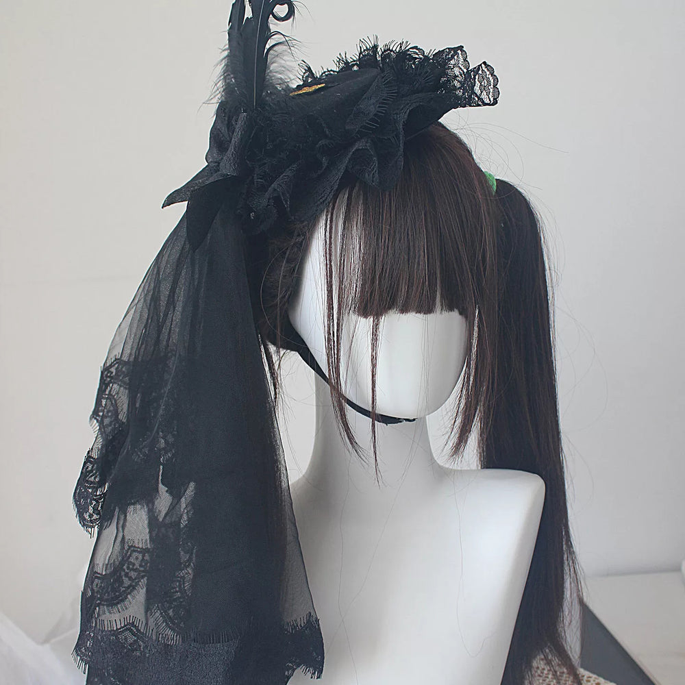 Black Lolita hat and veil designs with lace, ruffles and feather-inspired details on mannequins.