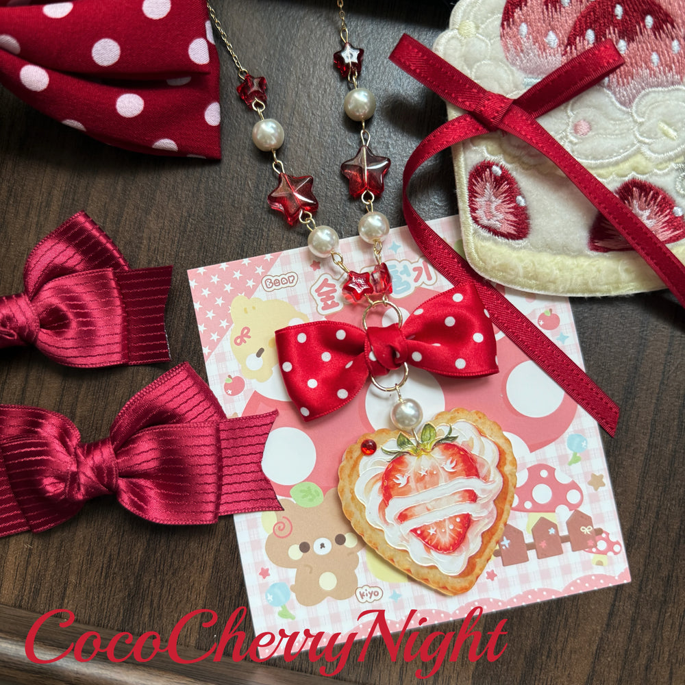 Creamy Cream Strawberry Tart necklace with a red polka-dot bow, pearl-like beads, red star-shaped accents and a strawberry tart pendant.