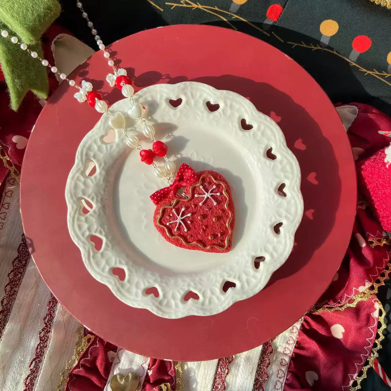 Beaded Christmas necklace with a red heart-cookie pendant and bow detail.