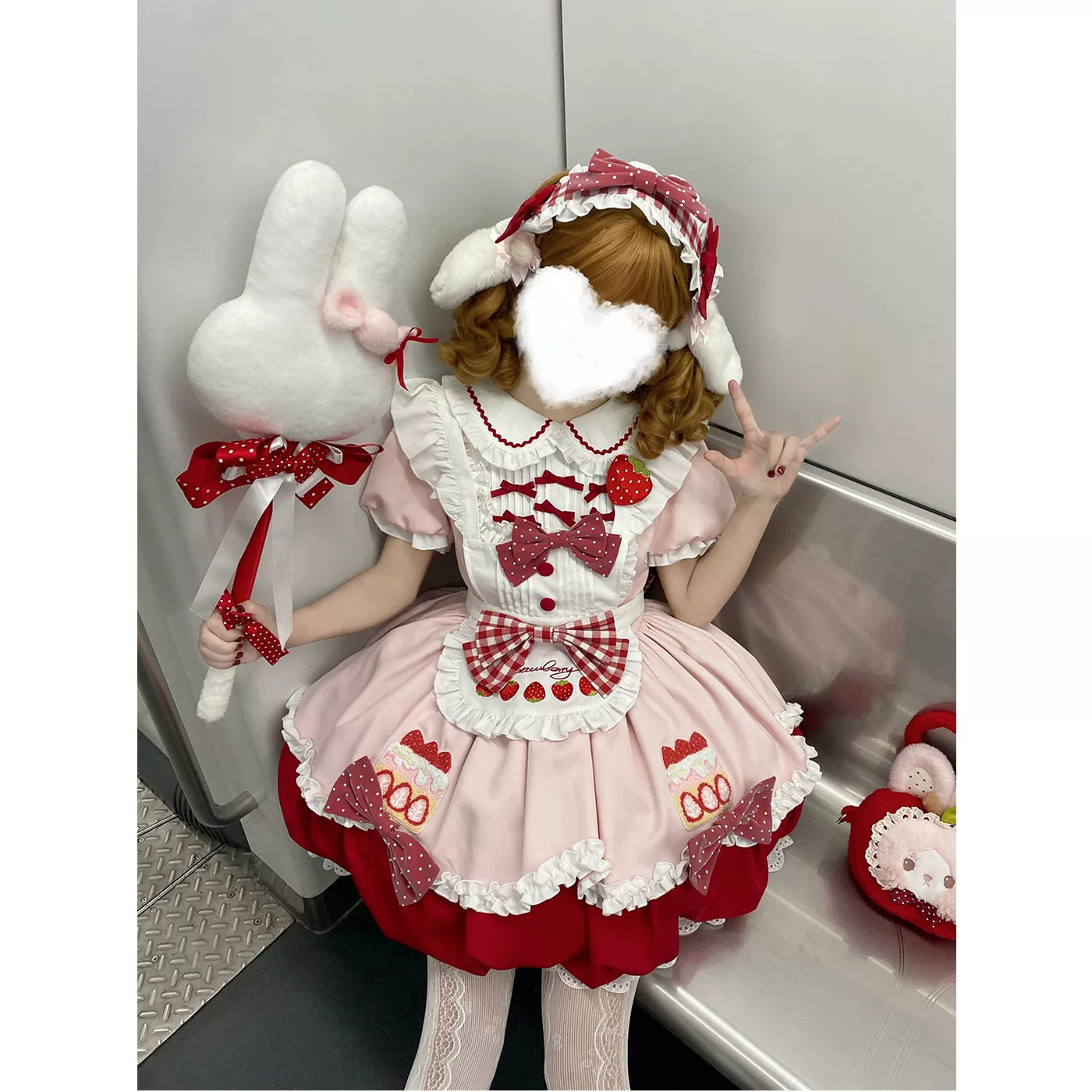 Pink JSK with a white ruffled apron and strawberry motifs
