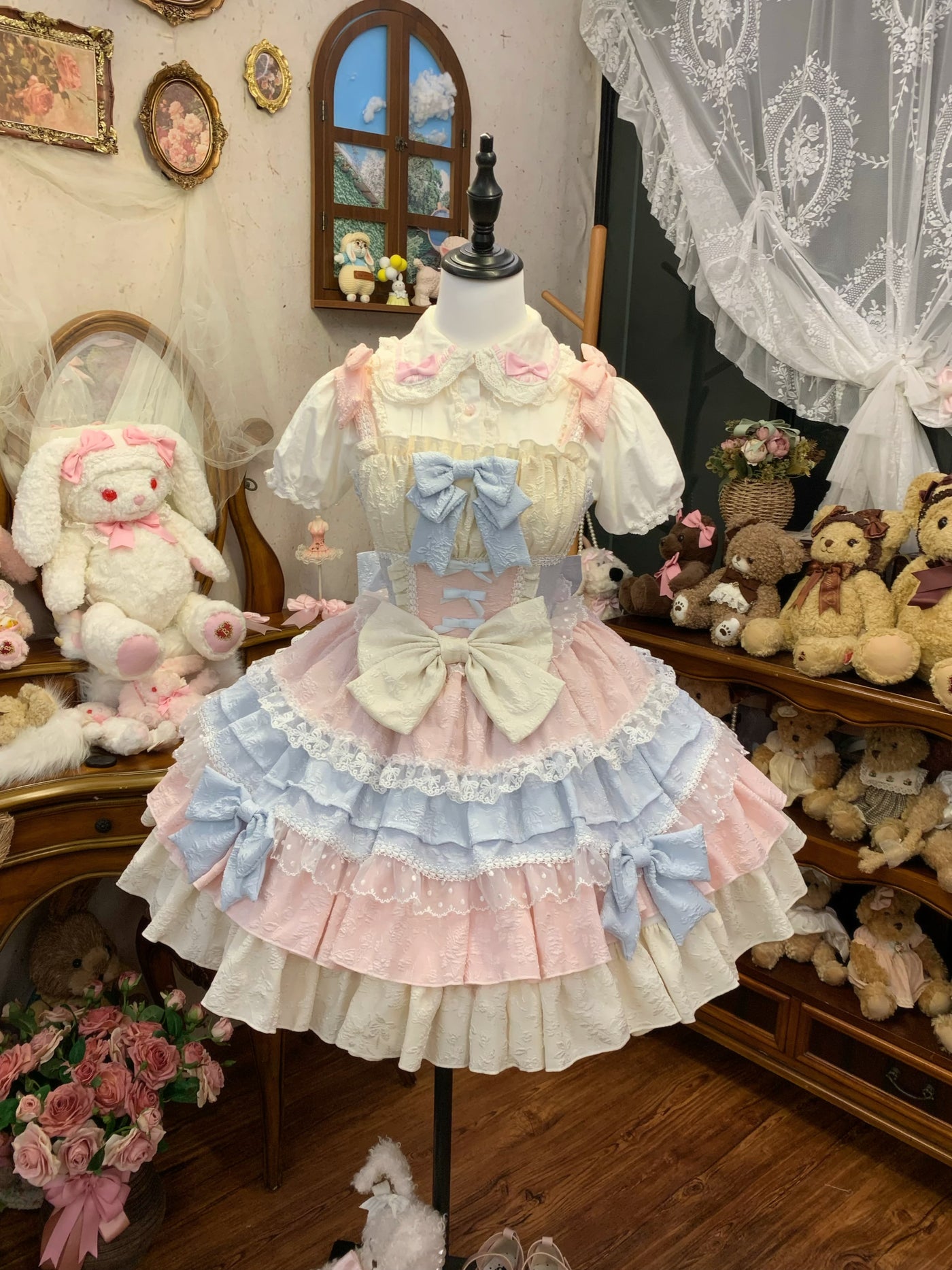 Back view of JSK on mannequin, showing corset-style ribbon lacing and large back bow