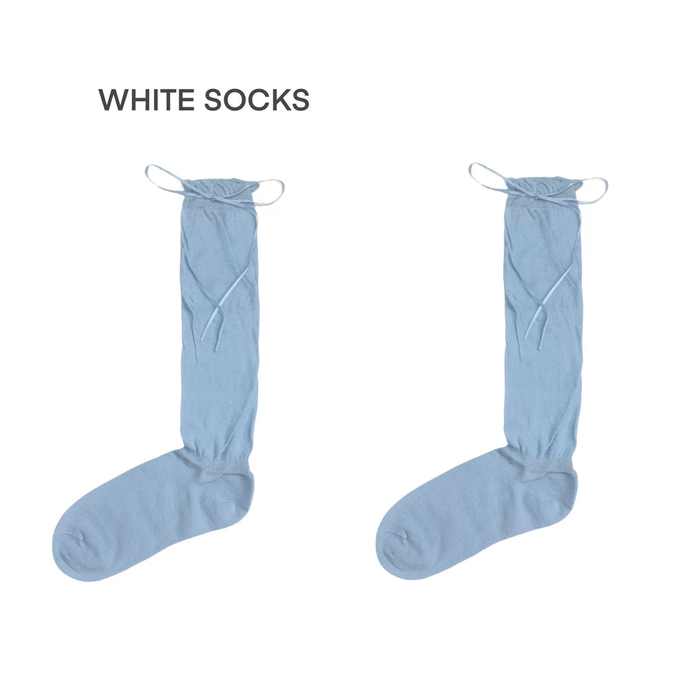 Light blue ribbon-tie scrunch socks shown in a flat lay.