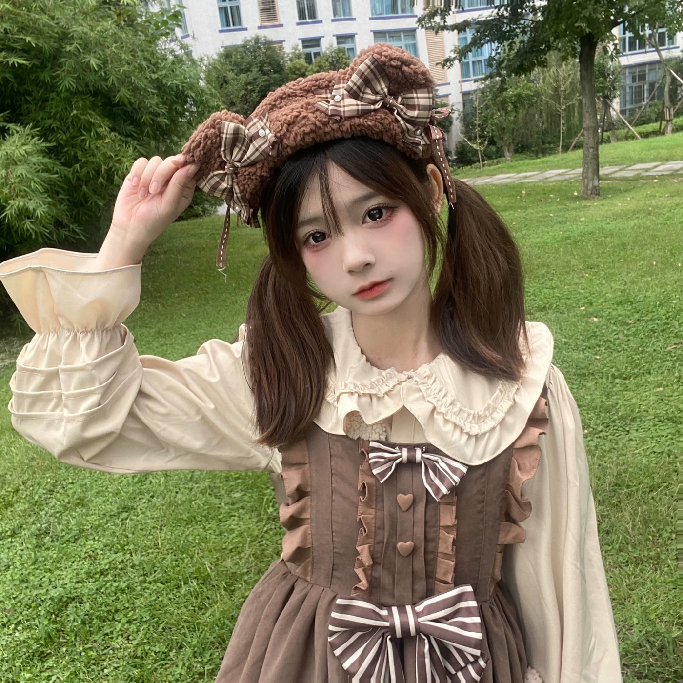 Model wearing a cocoa-brown bear-themed JSK with a cream blouse and bows.
