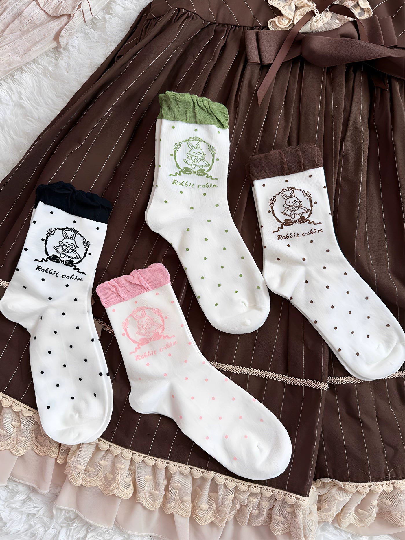 Rabbit Cabin short socks with ruffled cuffs and polka dots in black, mint green, brown, and pink