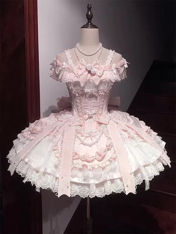 Creamy pink Lolita dress on a mannequin, showing lace bodice, layered skirt, and back bow