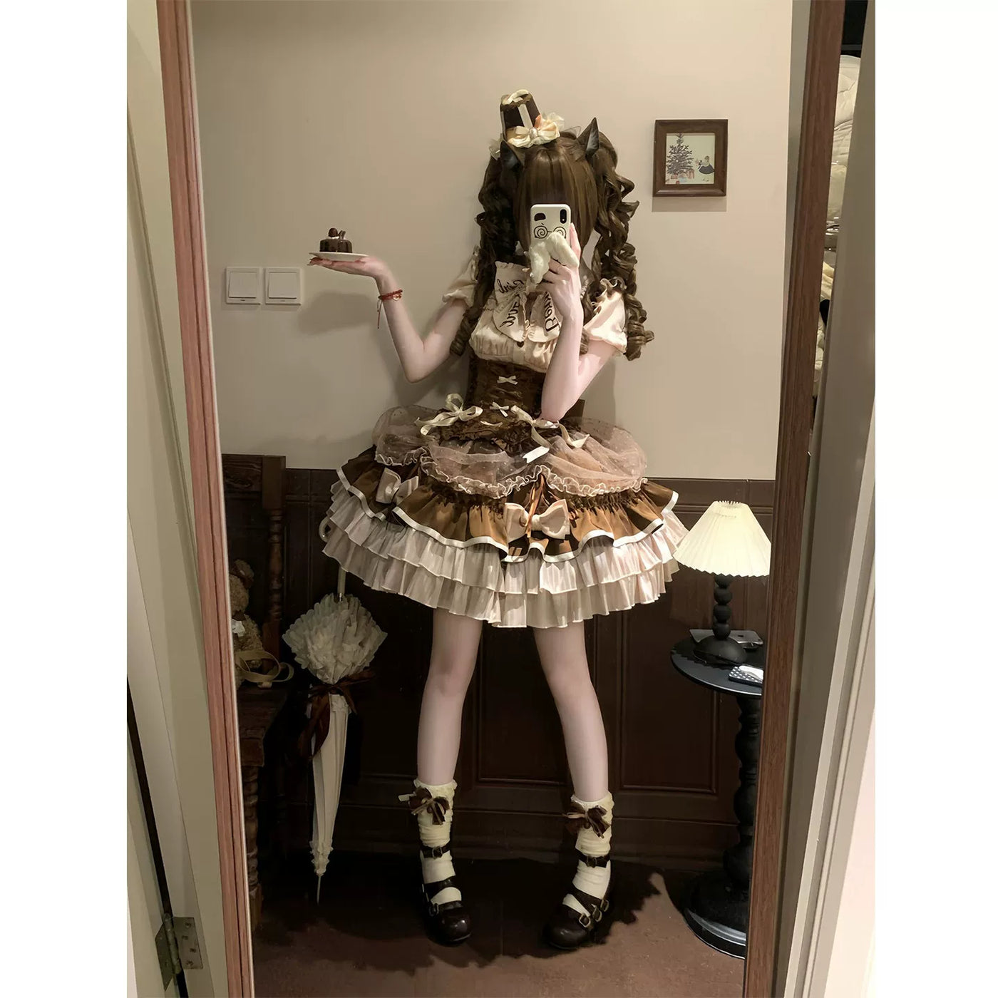 Brown-and-cream blouse and SK set worn by a model with layered ruffles and bows.