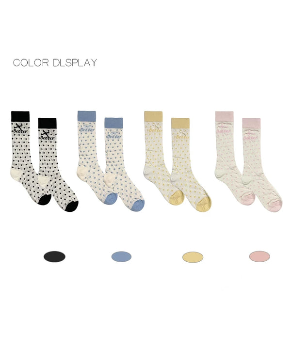Cream ribbed socks with yellow polka dots, a bow, and a wide cuff