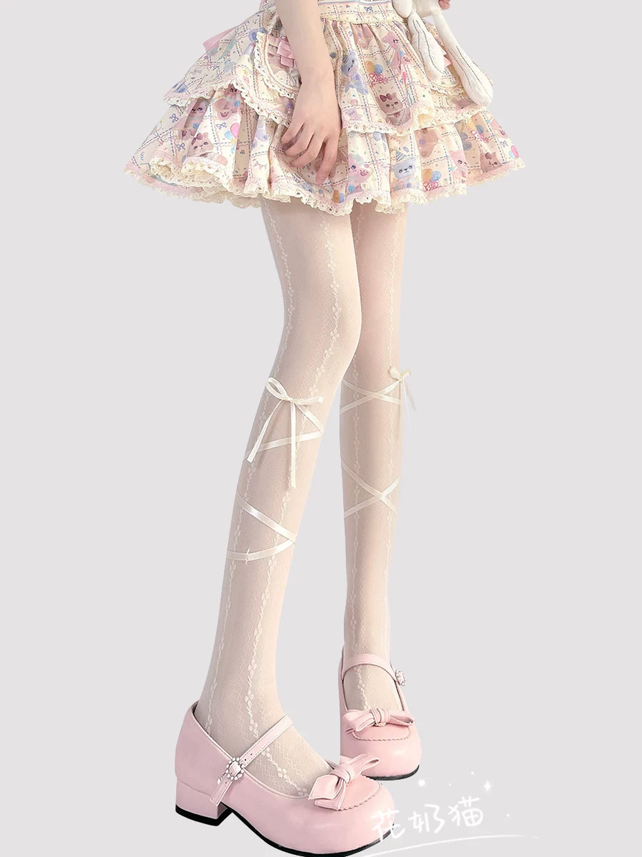 Milky white Sweet Lolita sheer tights with crisscross ribbon detailing and bow accents, laid flat