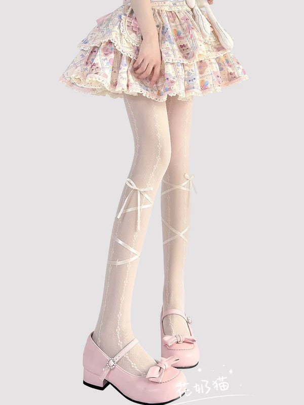 Milky white Sweet Lolita sheer tights with crisscross ribbon detailing and bow accents, laid flat