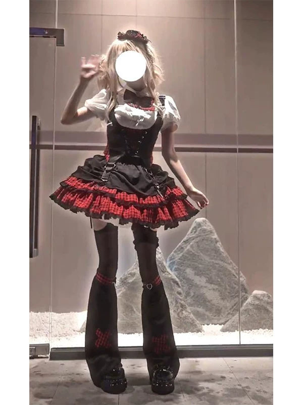 Black-and-red Lolita set with white shirt, fitted vest, plaid ruffled skirt and leg covers shown on a model.