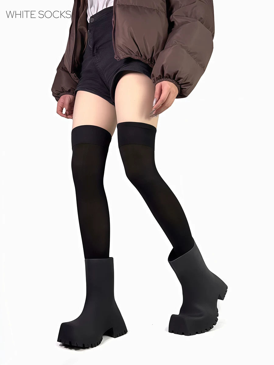Black and white over-the-knee socks shown with slouching shafts and tall black boots.